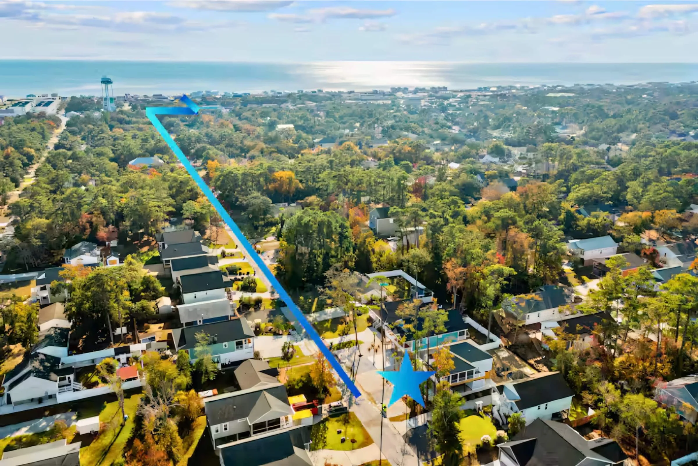 Drone view over Oak Island showing the tree-lined streets between the house and the ocean